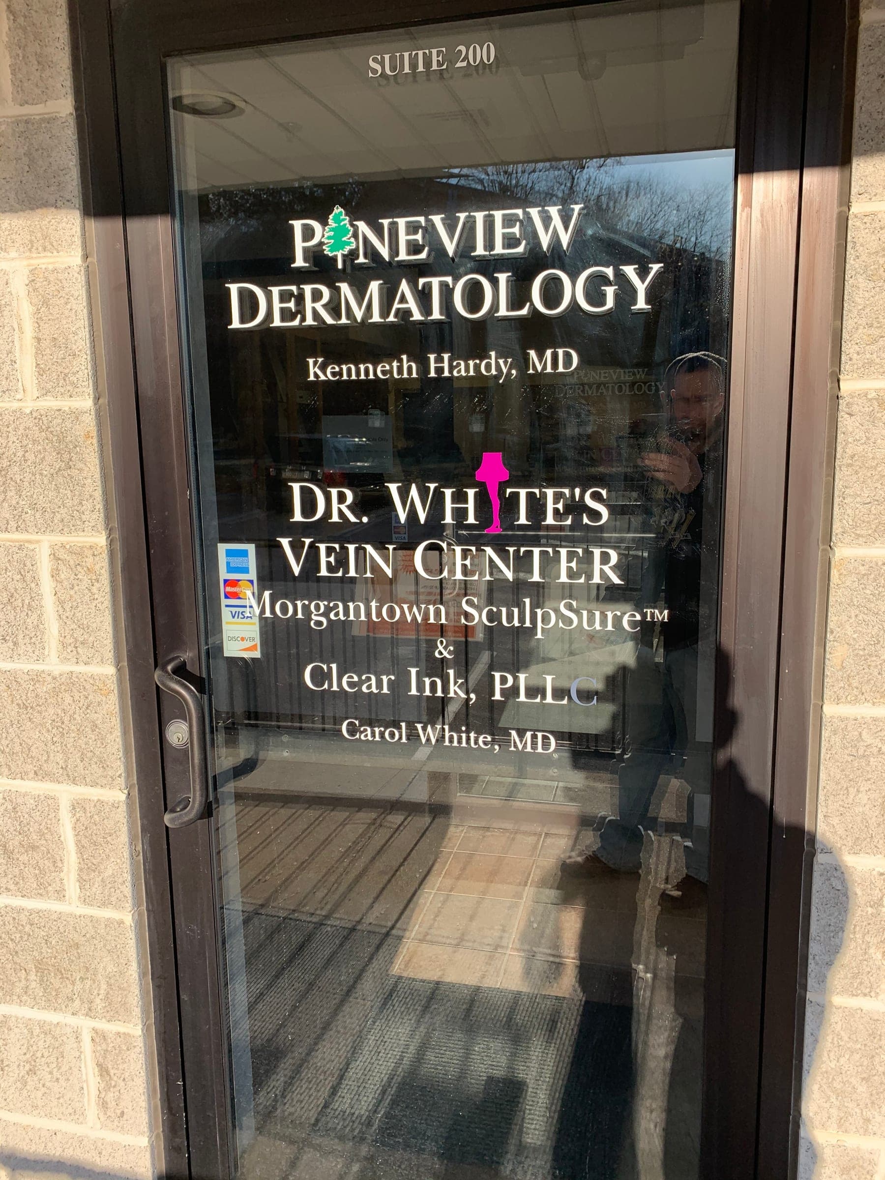 Glass office door with white vinyl lettering for Pineview Dermatology